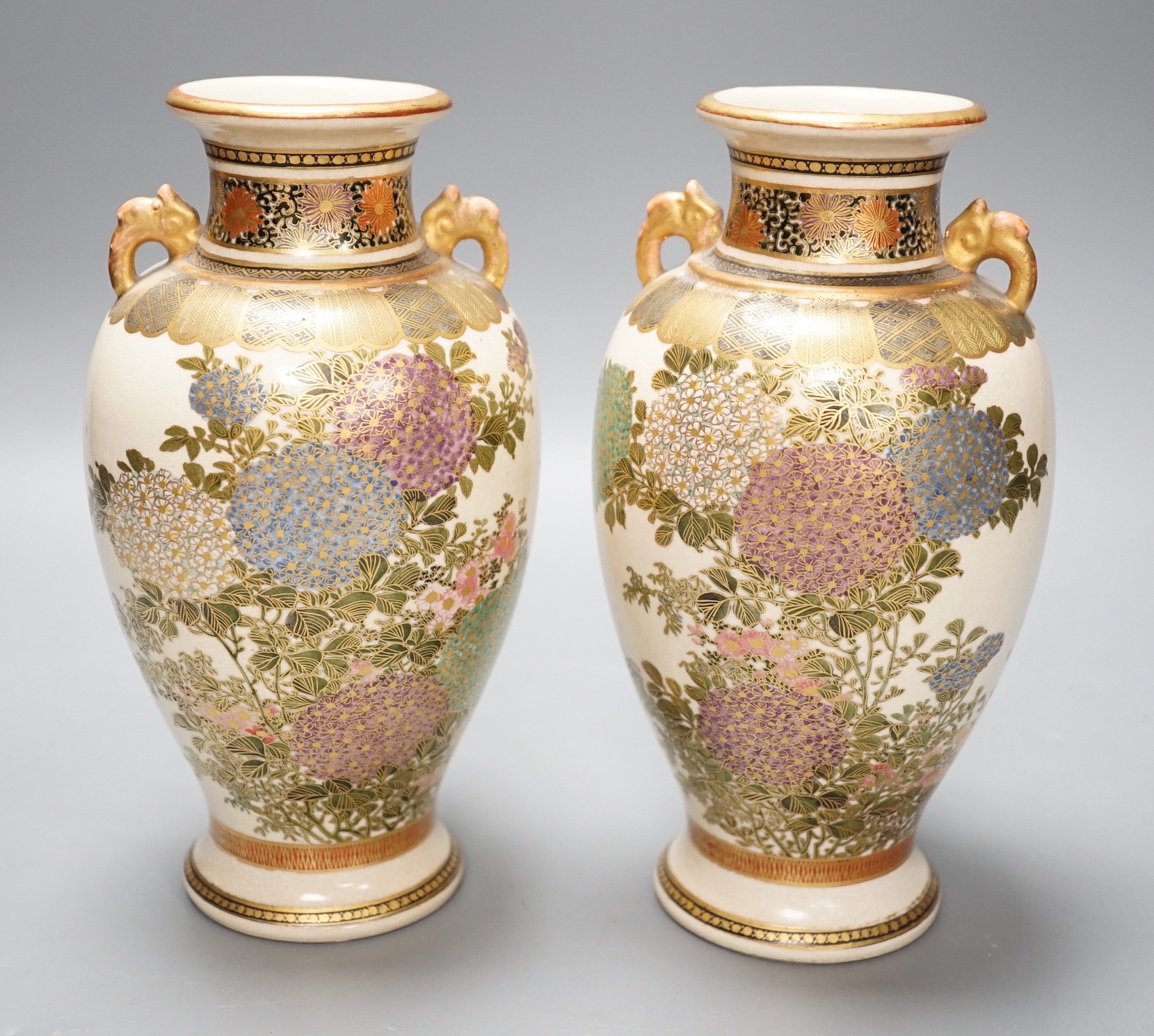 A pair of Japanese Satsuma pottery vases, 18.5cms high